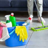 bucket-with-bottles-detergent-cleaning-equipment-housewife-cleaning-floor-with-mopping-stick